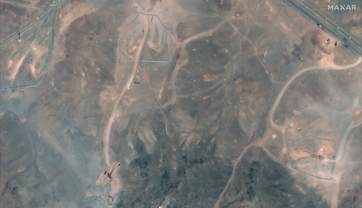 A lot going on at Fordow TODAY. Ventilation shaft and bomb penetration holes have been filled up. nn1. Large crane near large excavator working at old tunnel entrance. 2. Truck mounted borehole drilling rig parked nearby. 3. Trucks near tarmac road being filled up by bulldozer.