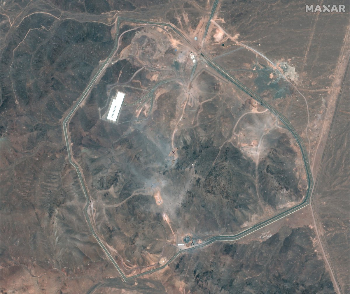 A lot going on at Fordow TODAY. Ventilation shaft and bomb penetration holes have been filled up. nn1. Large crane near large excavator working at old tunnel entrance. 2. Truck mounted borehole drilling rig parked nearby. 3. Trucks near tarmac road being filled up by bulldozer.