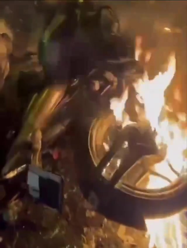 Rasht, N Iran Social media video of protesters setting fire to a motorcycle belonging to security forces who opened fire on them
