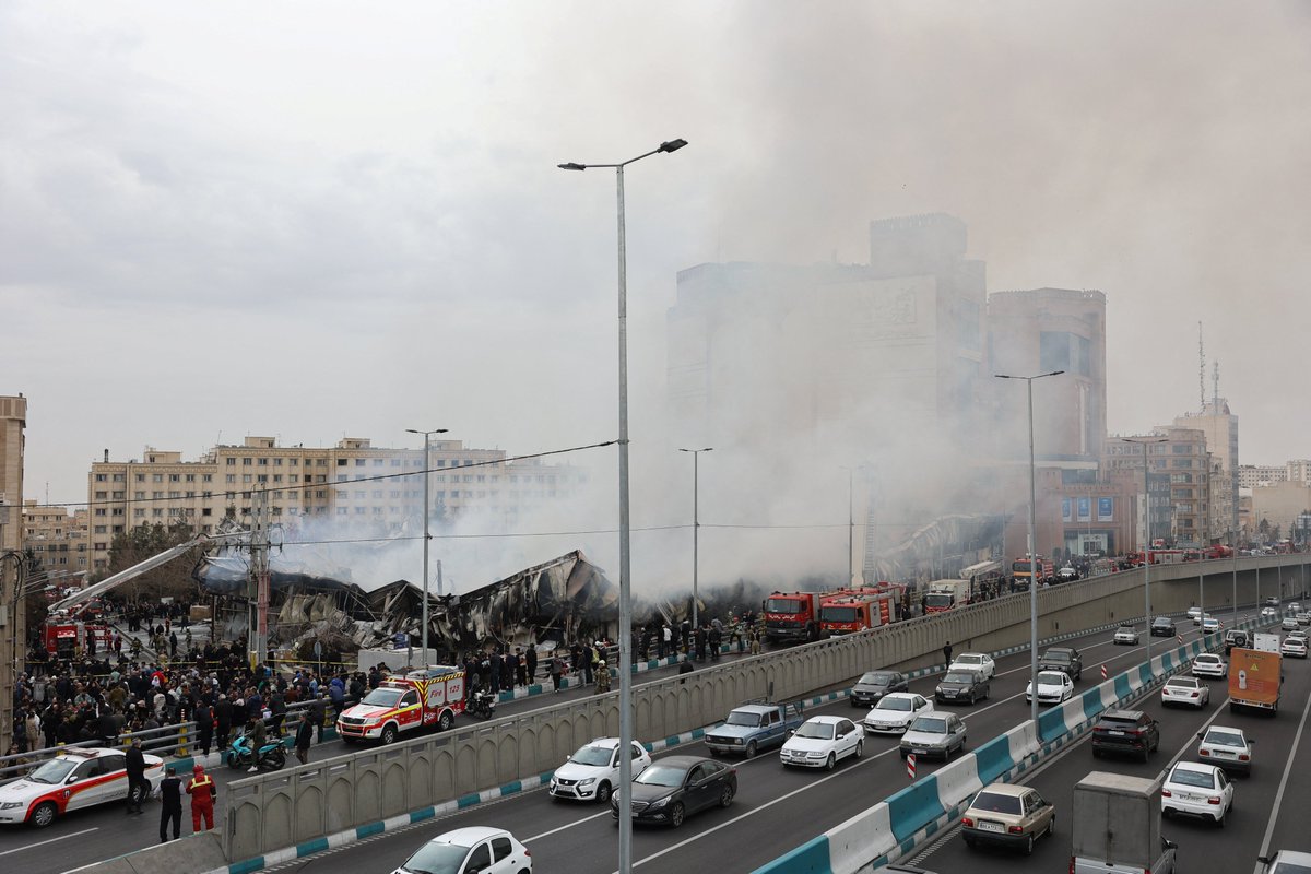 Smoke billowed over western Tehran on Tuesday as firefighters battled a major blaze at Janat Abad Market. The cause of the fire was not immediately clear