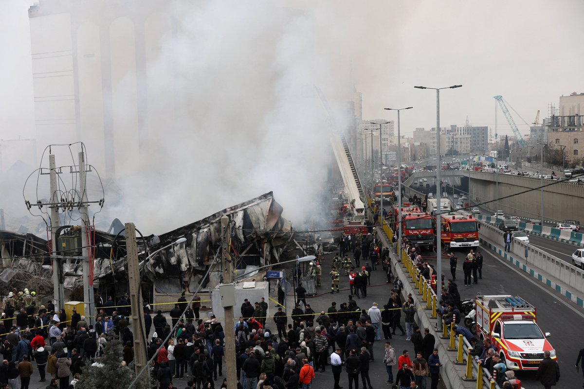 Smoke billowed over western Tehran on Tuesday as firefighters battled a major blaze at Janat Abad Market. The cause of the fire was not immediately clear