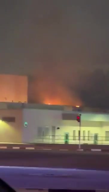 Smoke rises as a fire appears to be burning on the roof of one of the entrance buildings that are part of the U.S. Consulate in Dubai