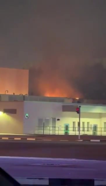 Smoke rises as a fire appears to be burning on the roof of one of the entrance buildings that are part of the U.S. Consulate in Dubai