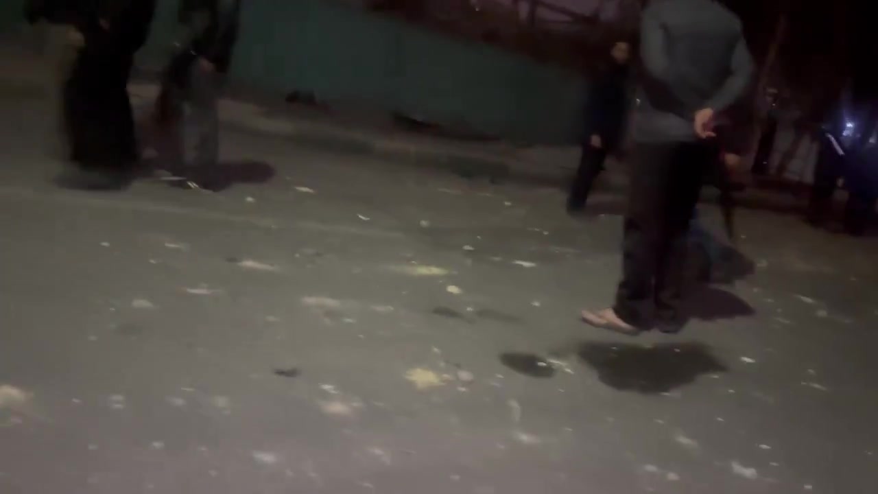 Residents in the Bisim district in south-east Tehran inspect the aftermath of a strike targeting the local police station, the roof of which appears to have been destroyed