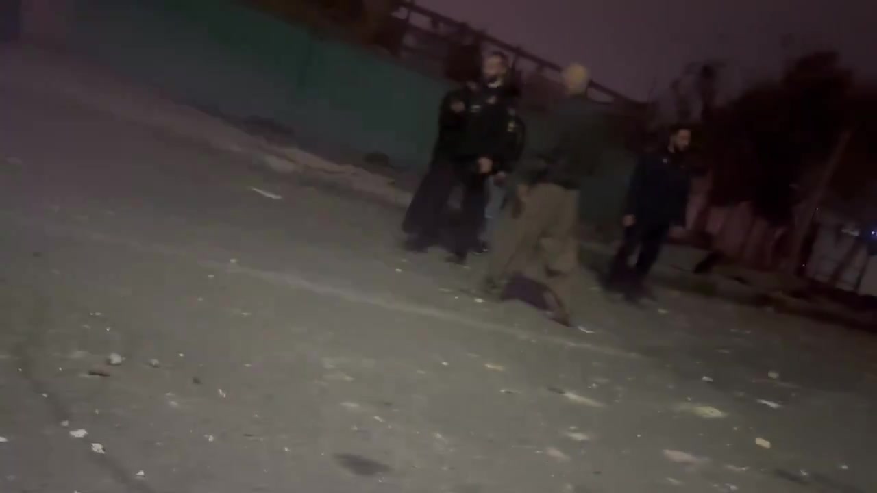 Residents in the Bisim district in south-east Tehran inspect the aftermath of a strike targeting the local police station, the roof of which appears to have been destroyed