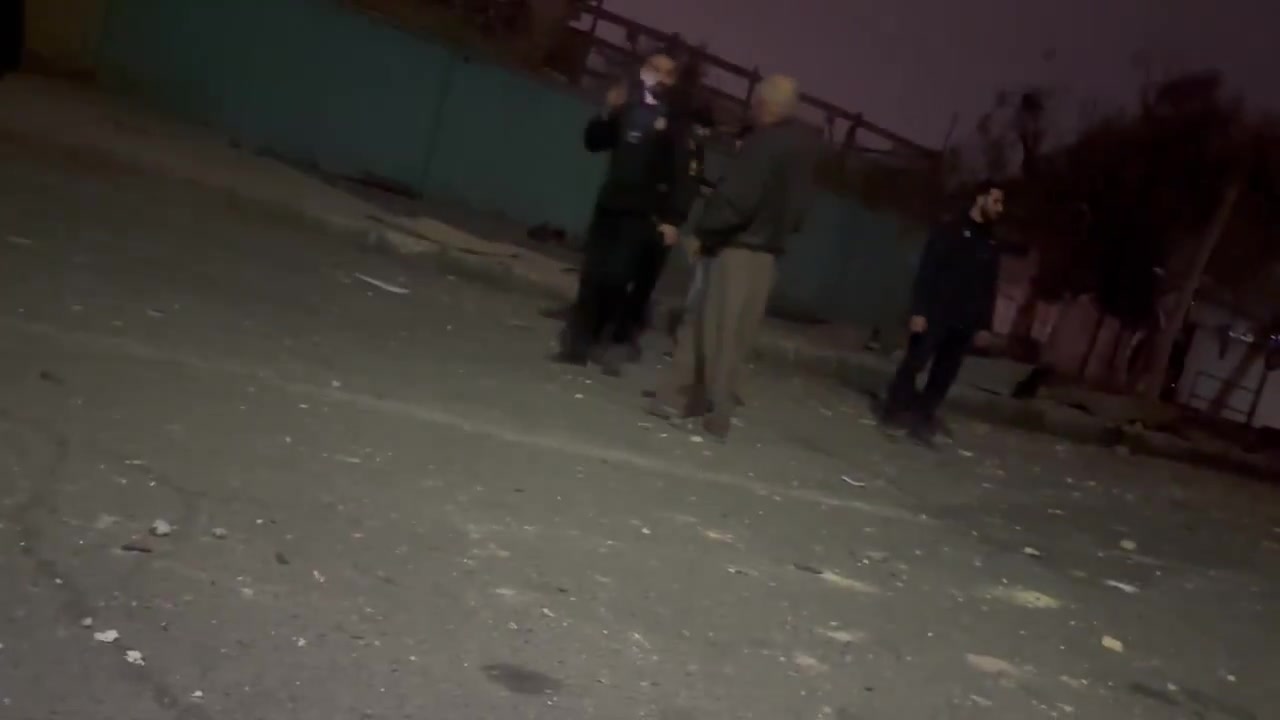Residents in the Bisim district in south-east Tehran inspect the aftermath of a strike targeting the local police station, the roof of which appears to have been destroyed