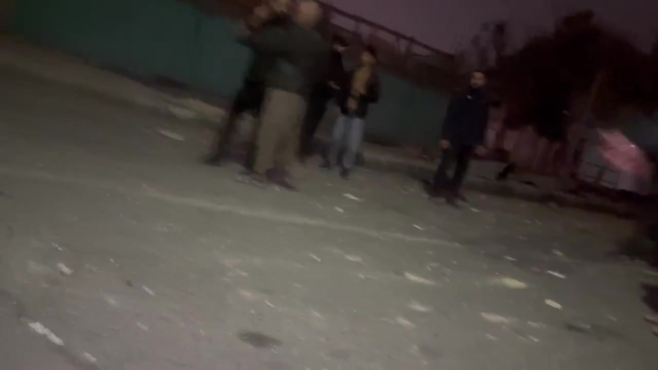 Residents in the Bisim district in south-east Tehran inspect the aftermath of a strike targeting the local police station, the roof of which appears to have been destroyed