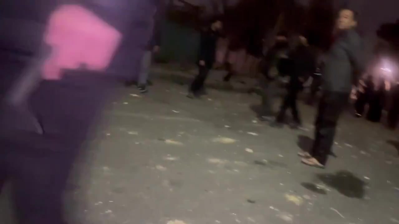 Residents in the Bisim district in south-east Tehran inspect the aftermath of a strike targeting the local police station, the roof of which appears to have been destroyed