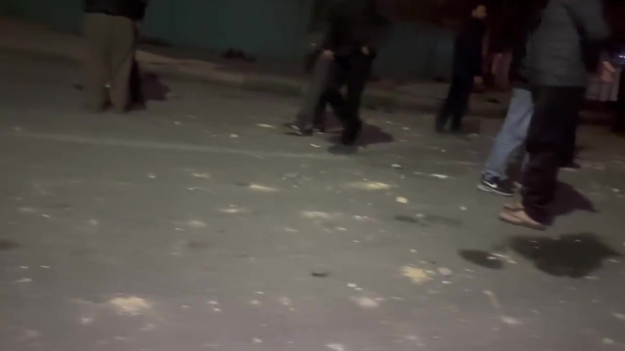 Residents in the Bisim district in south-east Tehran inspect the aftermath of a strike targeting the local police station, the roof of which appears to have been destroyed