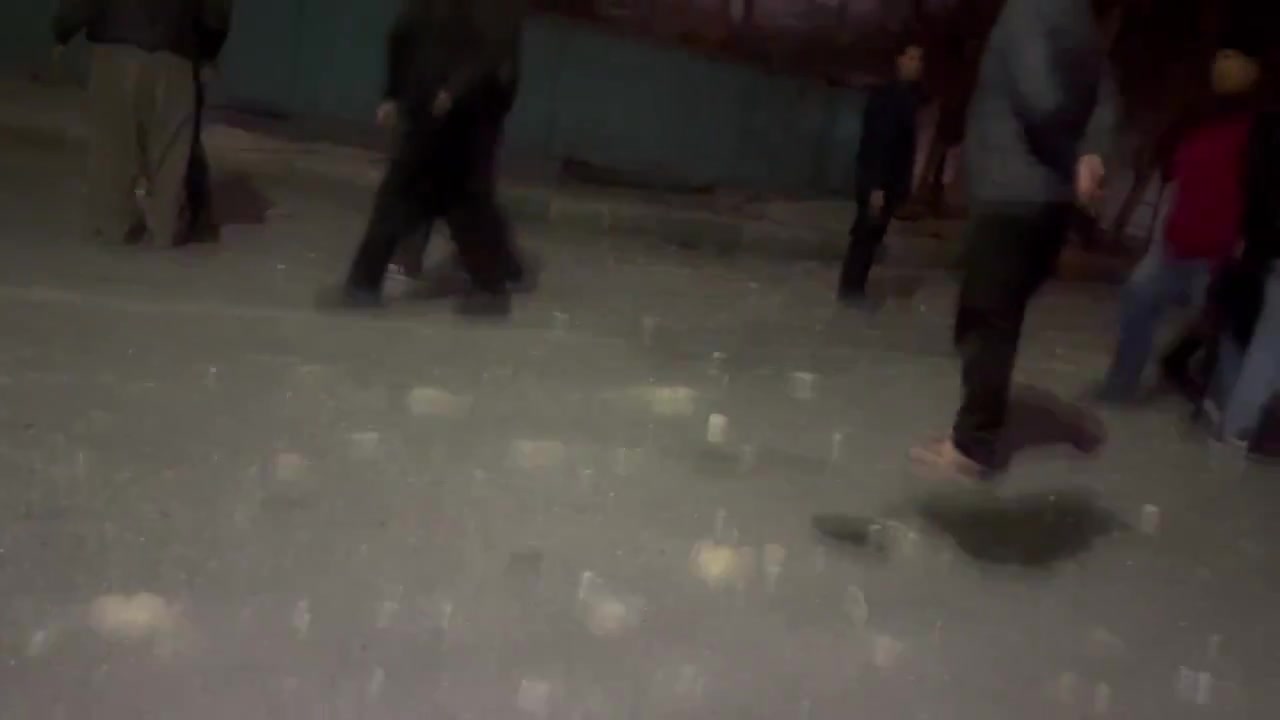 Residents in the Bisim district in south-east Tehran inspect the aftermath of a strike targeting the local police station, the roof of which appears to have been destroyed