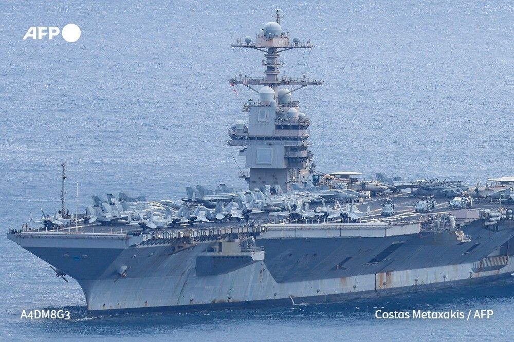 The USS Gerald R. Ford, the world's largest aircraft carrier that has been part of Middle East war operations, on Monday returned to a naval base in Crete, an AFP photographer said
