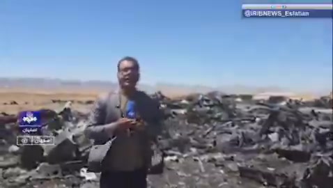 Iran’s state television report from the site of the wreckage of a U.S. aircraft and mentioning only two C-130s is destroyed. The reporter says this is the Parzan area in southern Isfahan