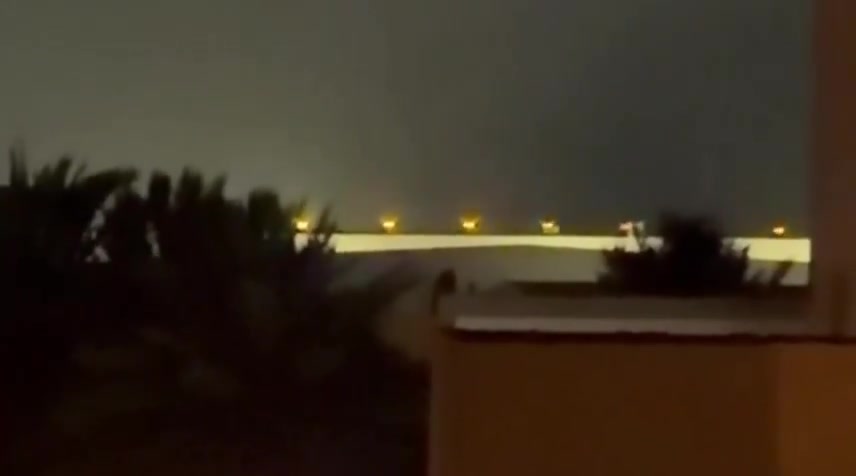 Iran's IRGC is launching a large-scale ballistic missile and drone attack on Kuwait and Bahrain in response to today's U.S. strikes on Iran. Reports indicate direct impacts on the U.S. Navy's 5th Fleet HQ in Bahrain, with footage showing plumes of smoke rising from the area