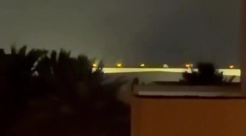 Iran's IRGC is launching a large-scale ballistic missile and drone attack on Kuwait and Bahrain in response to today's U.S. strikes on Iran. Reports indicate direct impacts on the U.S. Navy's 5th Fleet HQ in Bahrain, with footage showing plumes of smoke rising from the area